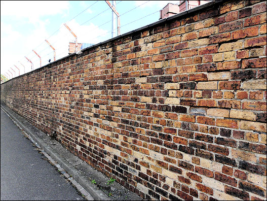 Canal wall separating old mill from canal behind Swift House, Cross Heath