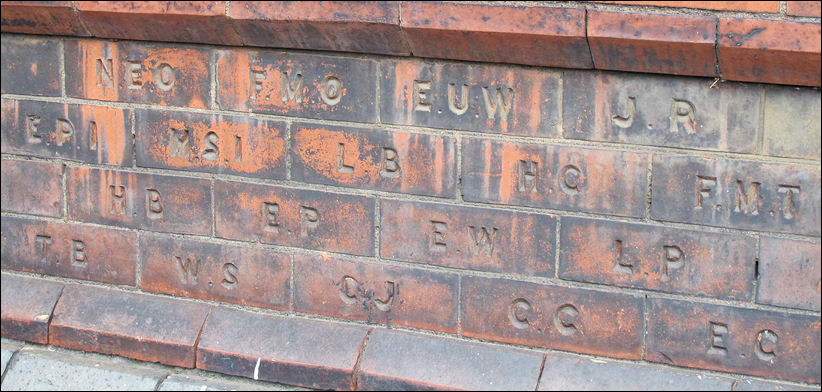 initialed bricks - probably the initials of donors to the building fund 