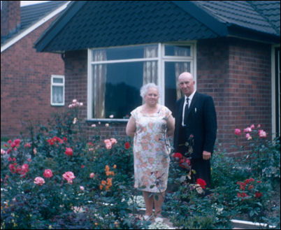 Albert Bentley and Mrs T. Bentley in the rose garden outside their house