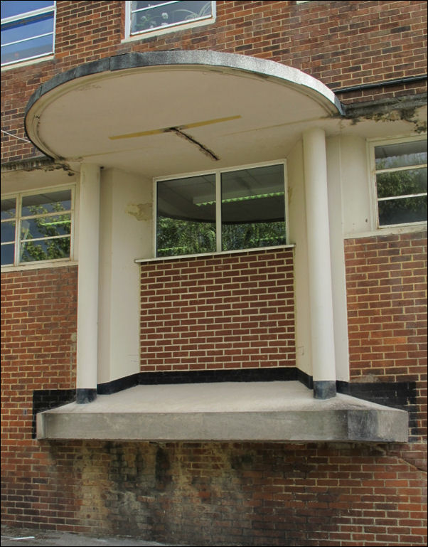 a bricked up entrance on the frontage - the original curved steps wound round from one side 