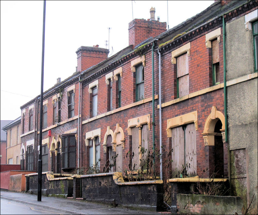 the same houses in January 2011 - boarded up and awaiting demolition as part of a clearance programme 