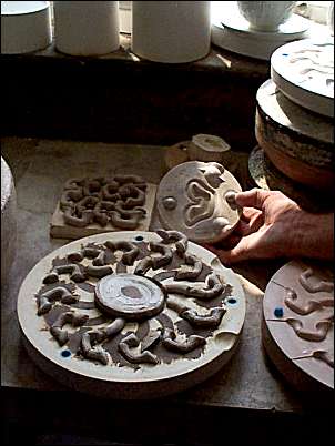 Cup handle moulds being checked for accuracy by producing trials