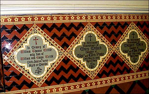 tiled dado with high glazed frieze and quatrefoil memorial tiles inset
