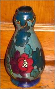 Decoro vase featuring a bird of paradise and peonies. 