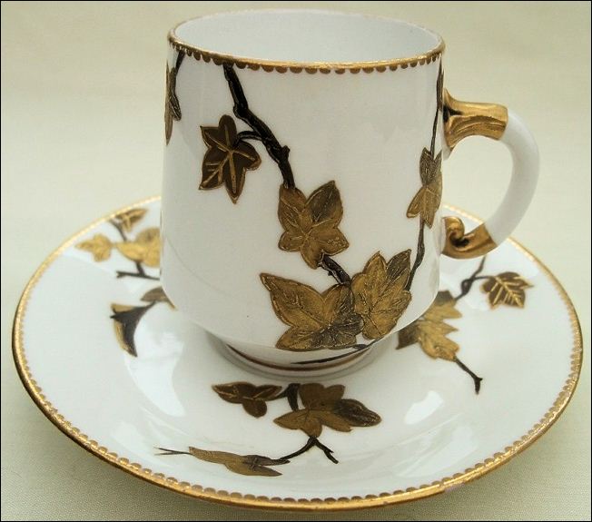 E J D Bodley demitasse cup and saucer with guilded leaves
