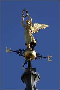 "dominated by the gold angel of the town hall spire"