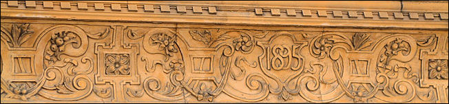 a frieze with decorative relief work runs the whole length of the building faade