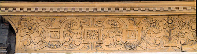 a frieze with decorative relief work runs the whole length of the building faade