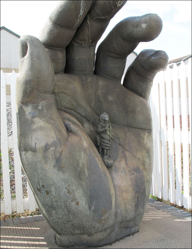 Hand with Chronos, Stoke Railway Station - by Vincent Woropay