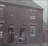 Two houses in John Street - the grime from the smoke of the pottery factories is evident