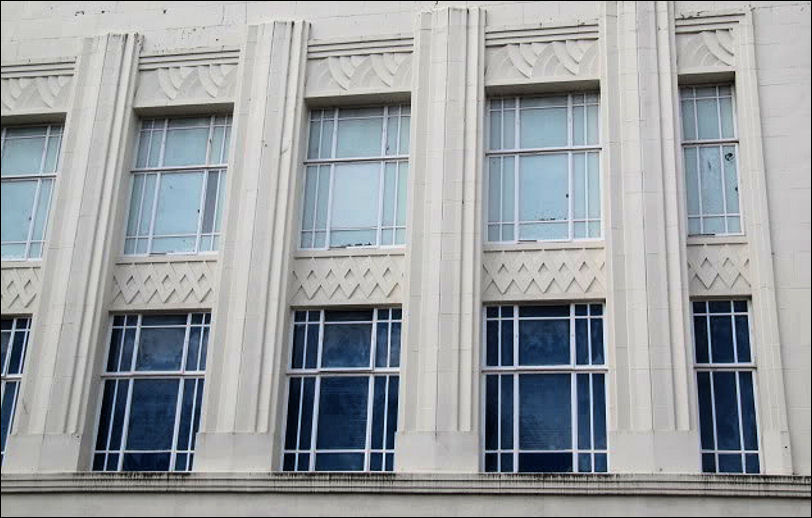 steel frame windows, vertical features and geometric design panels are key art deco features 