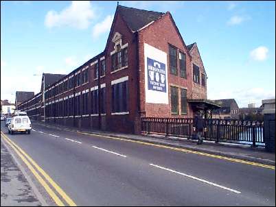 Looking up Lichfield Street with the Bridgewater Pottery factory in the centre of the picture - the Caldon Canal is visible between the railings of the bridge on the right of the picture.