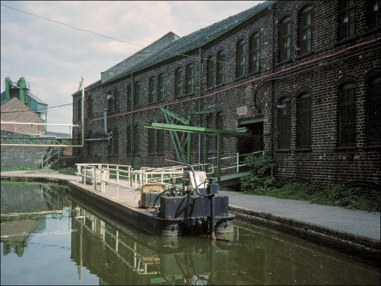 similar view of the Imperial Pottery -  a barge is waiting to be loaded with ware to be taken for packing