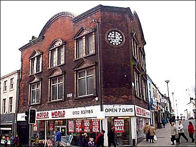 Shop frontage on corner of Tower Square and High Street