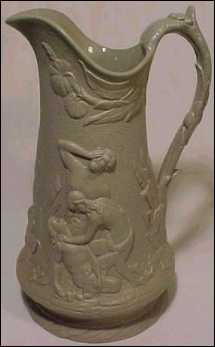 Salt glazed pitcher with heavily embossed Greek mythological figures
