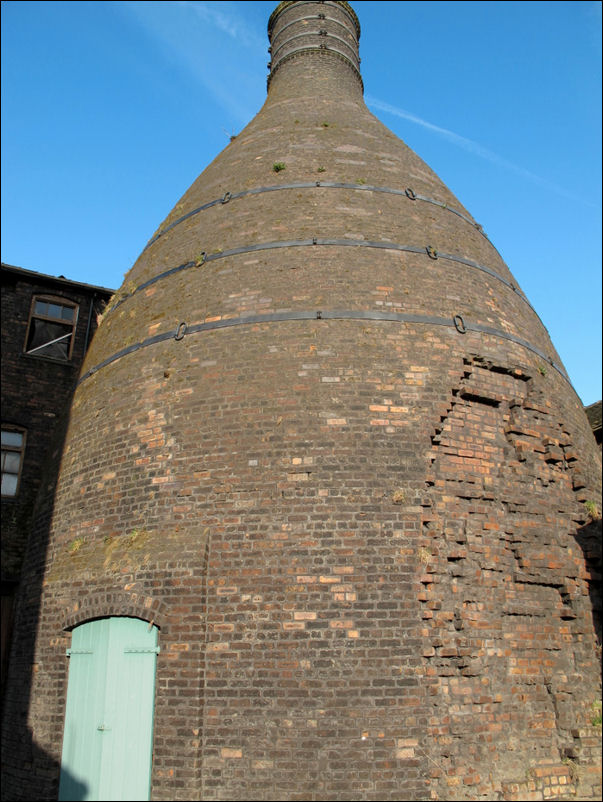 the huge size of this bottle kiln dominates the picture