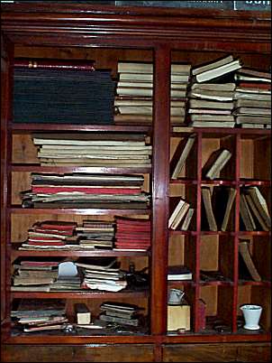 The cupboards in the office are packed with notebooks inscribed with copper-plate writing.