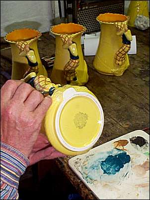 Painting the detail on the golfer jug